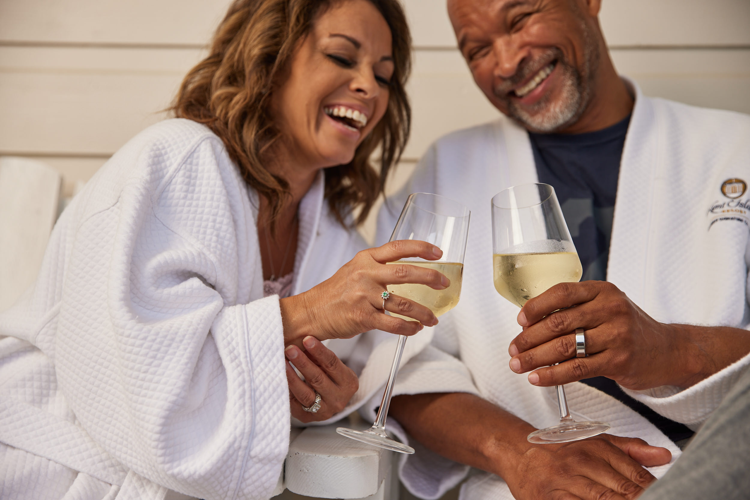 A couple drinking wine and laughing at Kent Island Resort